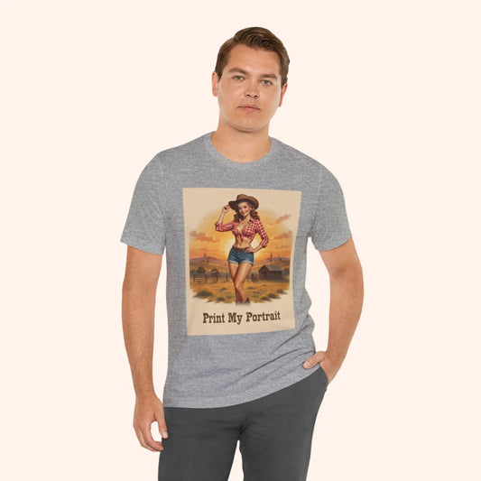 Man wearing a gray t-shirt with a graphic of a woman in a cowboy hat and plaid shirt, set against a desert landscape.